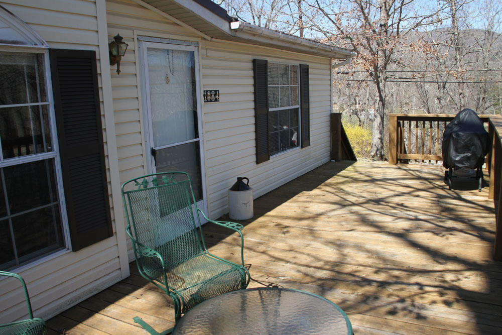 1084 Treasure Lane Blue Ridge, VA 24064 - Photo 9 of 37 a view of balcony with two chairs and a fire pit