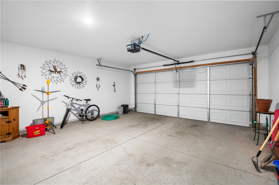 3623 East Andrea Drive Kingman, AZ 86409 - Photo 27 of 40 The property features a garage with a concrete floor, a white paneled garage door, and white painted walls
