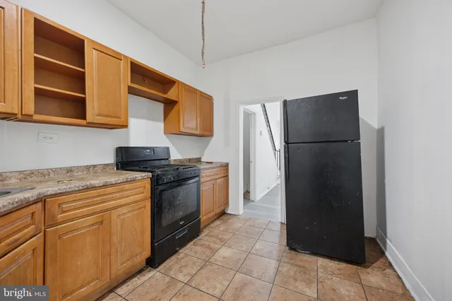 a kitchen with a refrigerator and a sink