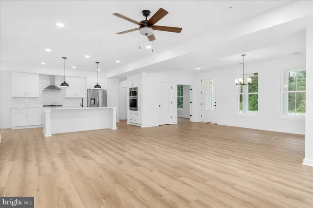 a view of a kitchen with a sink stainless steel appliances and cabinets