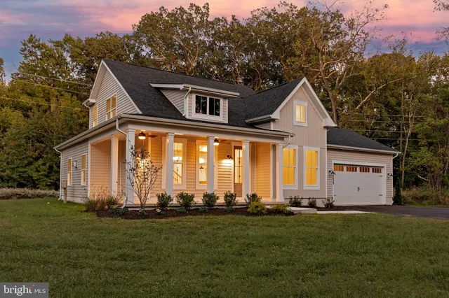 a front view of house with a garden