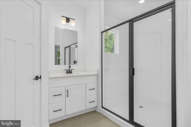 a bathroom with a double vanity sink and mirror