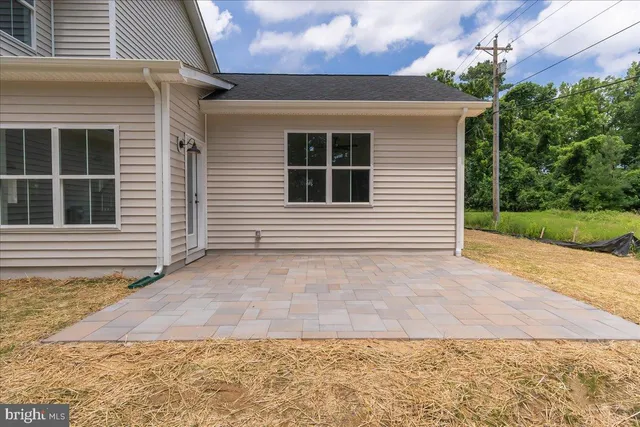 an aerial view of residential houses with outdoor space and trees