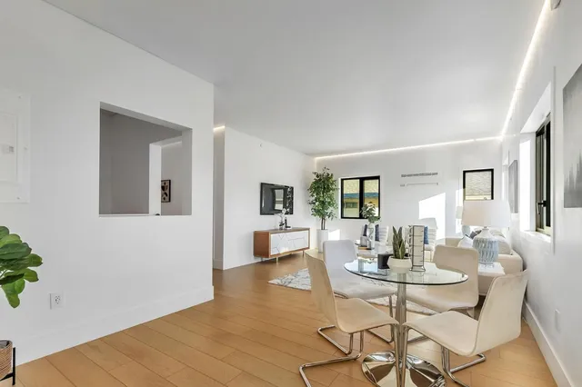 a bedroom with a bed and painting on the wall