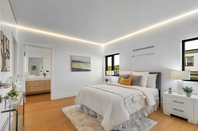 a bathroom with a granite countertop sink and a toilet