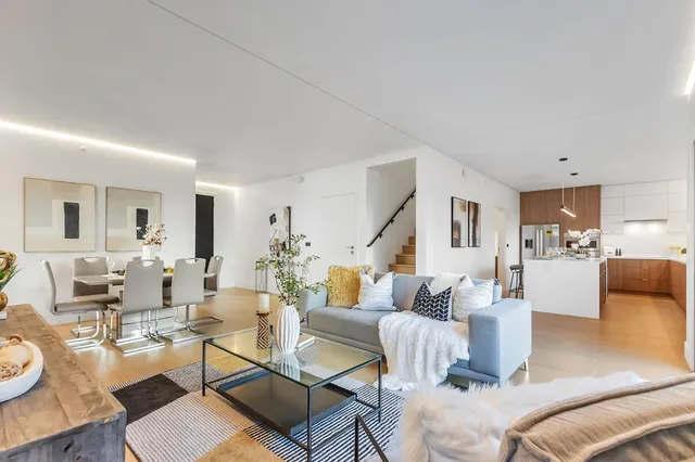 a kitchen with stainless steel appliances kitchen island granite countertop a sink and refrigerator
