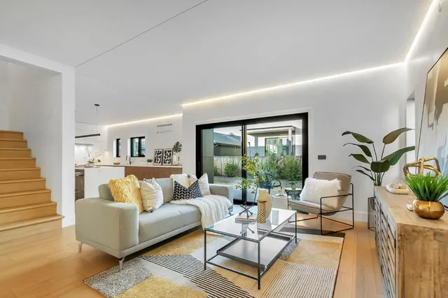 a large kitchen with kitchen island a sink a counter space and stainless steel appliances