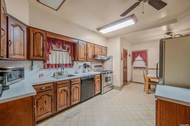 a kitchen with a sink refrigerator and cabinets