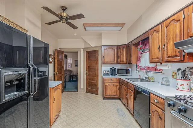 a kitchen with stainless steel appliances granite countertop a refrigerator a sink dishwasher a stove and a sink