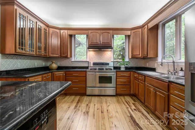 a kitchen with a stove a sink and a microwave