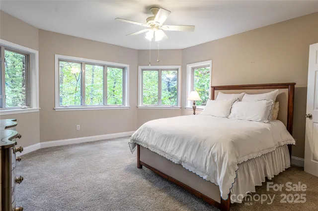 a spacious bedroom with a bed and a chandelier