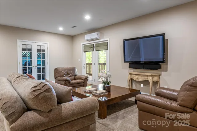 a living room with furniture a flat screen tv and a window