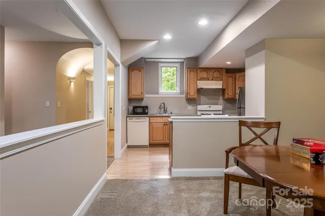 a kitchen with a sink cabinets stainless steel appliances and a counter top space