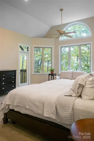 a bedroom with a large bed and a large window