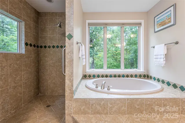 a white bath tub sitting in a bathroom next to a window