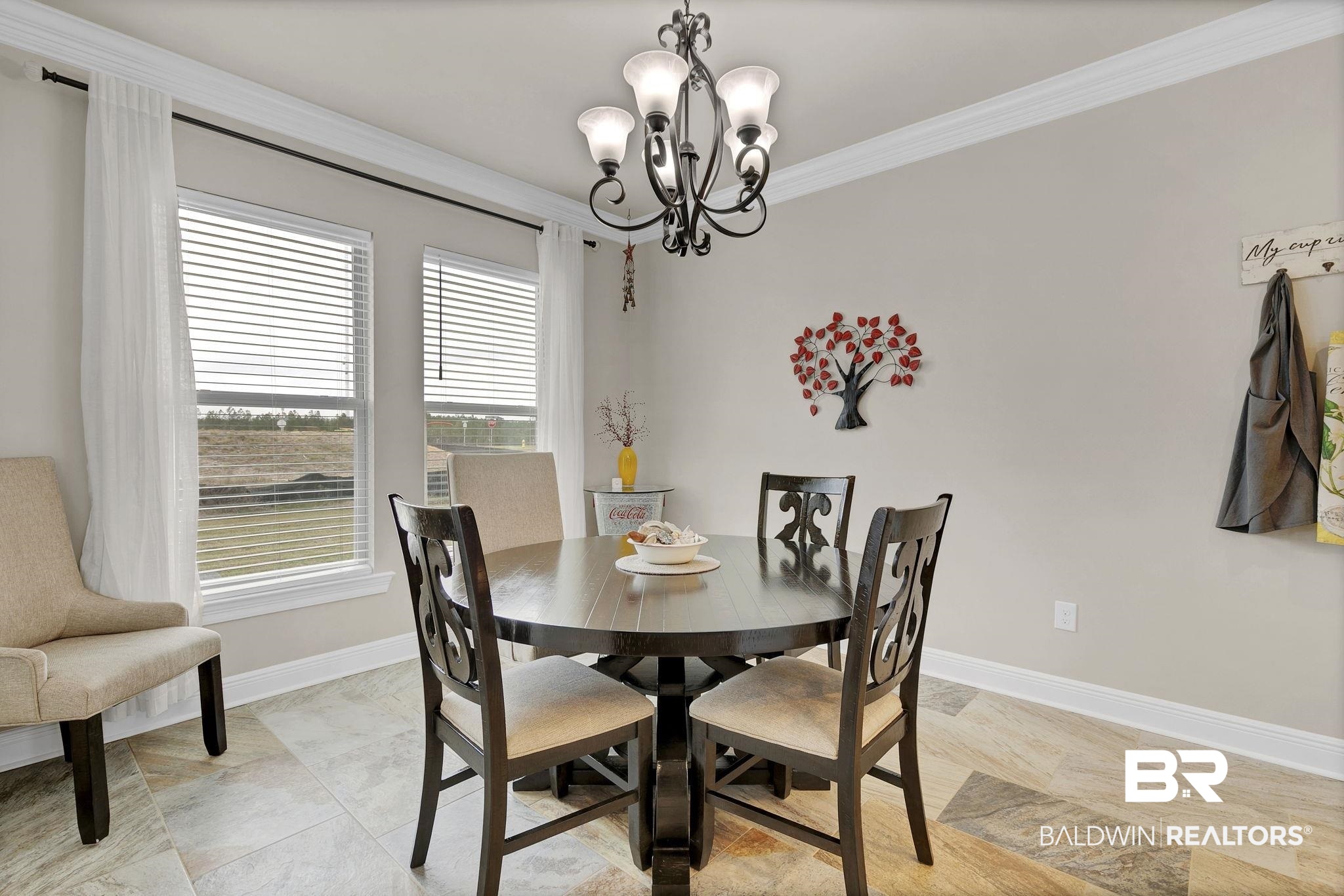 11247 Thistledown Loop Spanish Fort, AL 36527 - Photo 19 of 72 Dining space featuring an inviting chandelier, baseboards, and crown molding