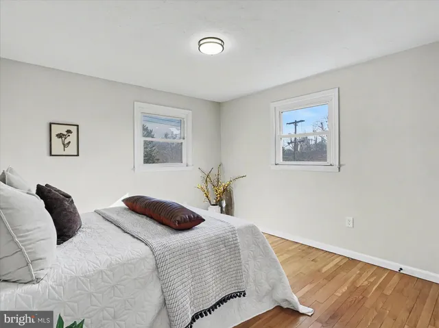 a bedroom with a bed and the painting on the wall