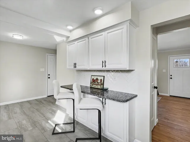 a kitchen with stainless steel appliances granite countertop a cabinets and a wooden floor