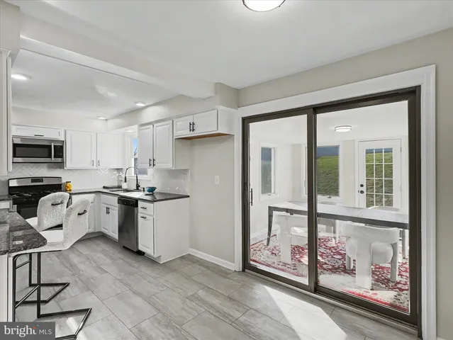 a kitchen that has a lot of cabinets in it and appliances