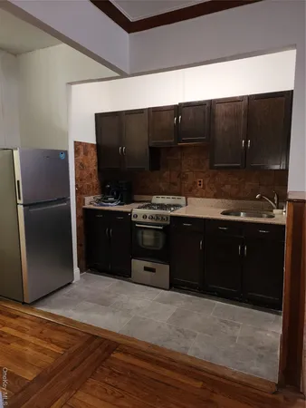 a kitchen with a stove and a refrigerator