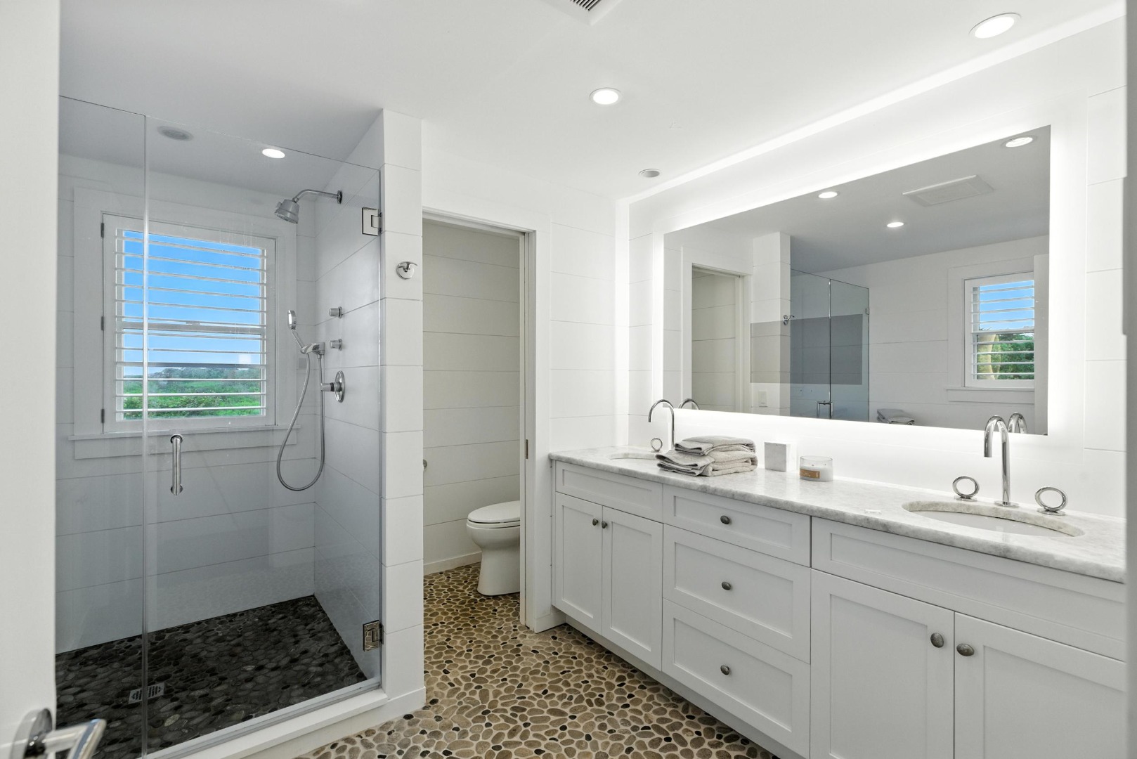 45 Starbuck Road Nantucket, MA 02554 - Photo 36 of 42 a spacious bathroom with a granite countertop sink a mirror a toilet and a shower