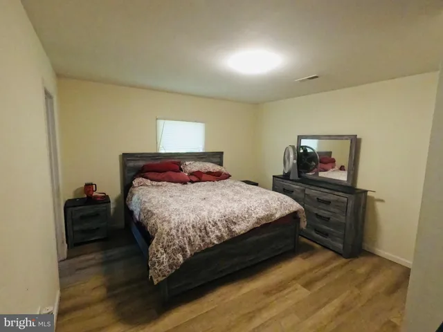 a bedroom with a bed and dresser
