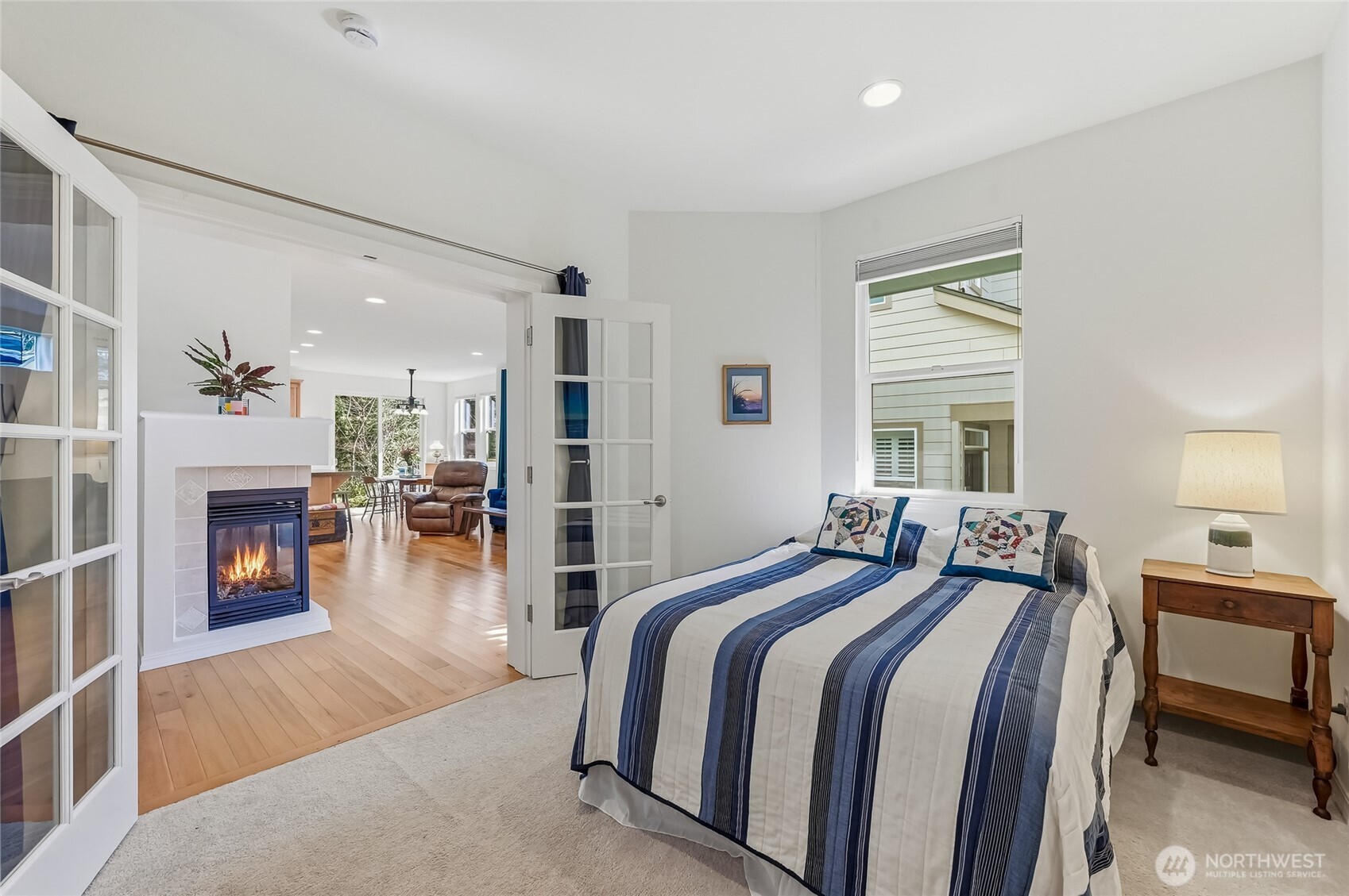 24264 Northeast Vine Maple Way Redmond, WA 98053 - Photo 16 of 31 a spacious bedroom with a bed and a fireplace