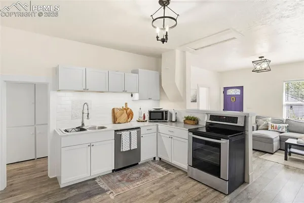 a kitchen with a sink cabinets and stainless steel appliances