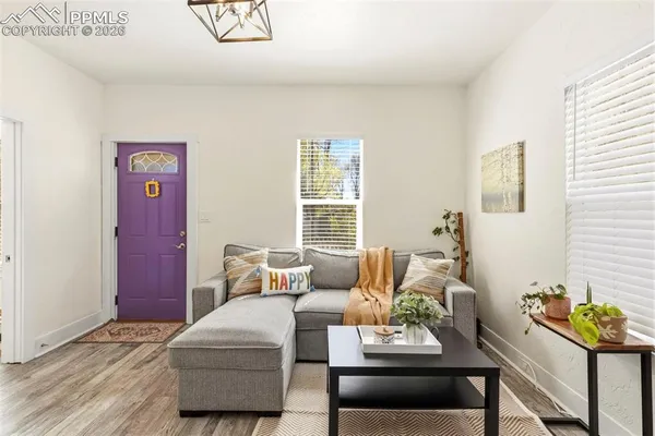 a living room with furniture and wooden floor