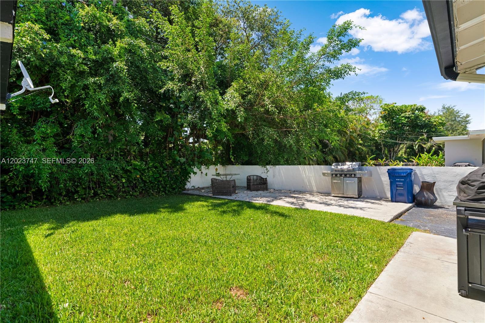 11515 Southwest 81st Road, Unit 11515 Pinecrest, FL 33156 - Photo 30 of 33 a house view with a sitting space and garden