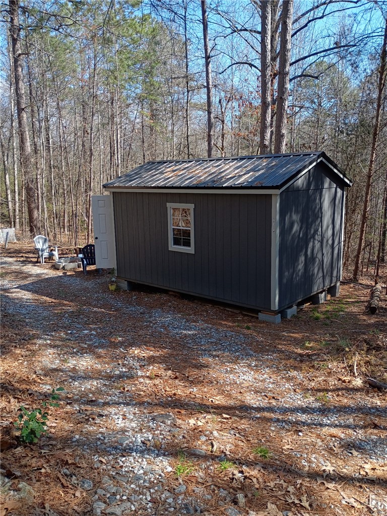 163 A Dixon Road Westminster, SC 29693 - Photo 5 of 9 This outdoor storage unit offers practicality and charm, nestled among the trees.