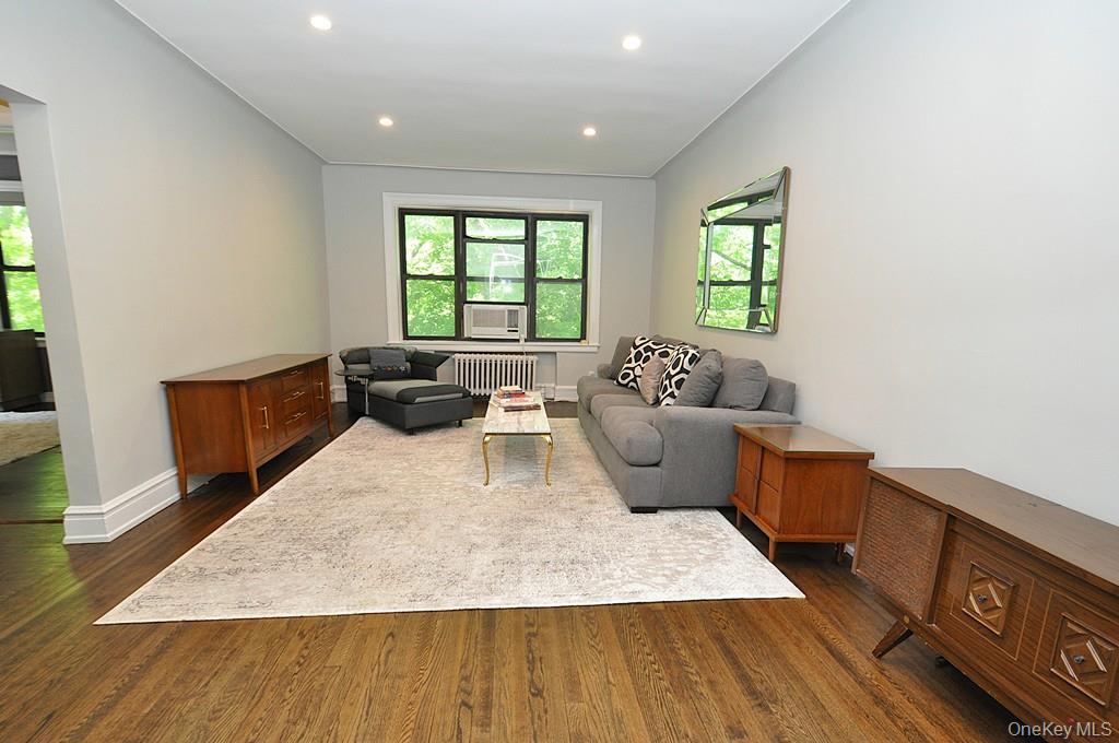 143 Garth Road, Unit 4P Scarsdale, NY 10583 - Photo 7 of 44 Bright and Sunny living room overlooks Garth Woods and has recessed lighting and hardwood floors.