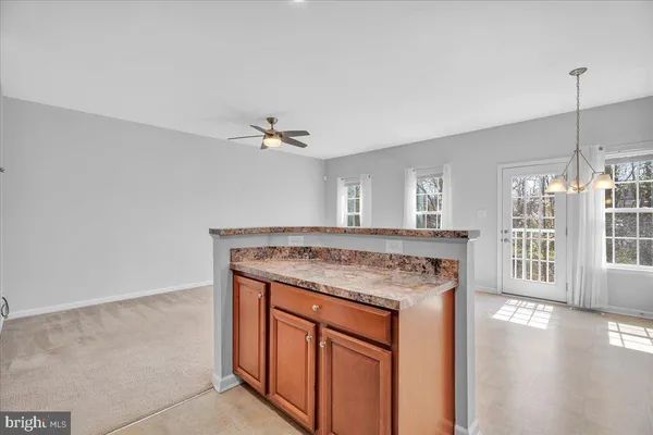 a kitchen with stainless steel appliances granite countertop a stove a sink dishwasher and a refrigerator