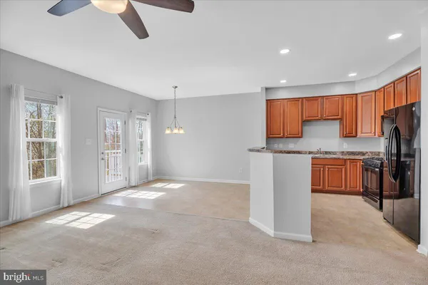 a kitchen with a stove and a wooden floor