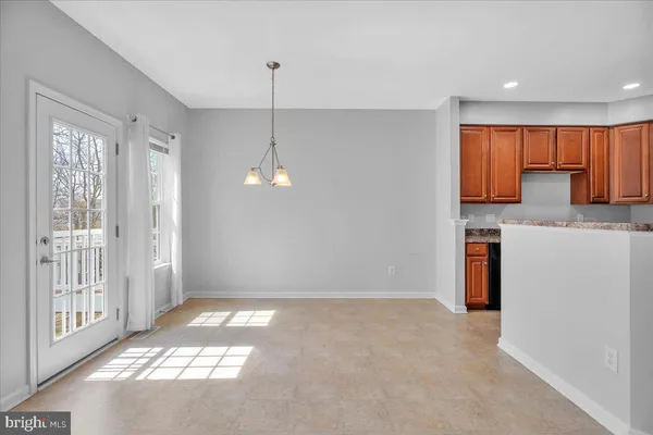 a view of a kitchen with a sink and refrigerator