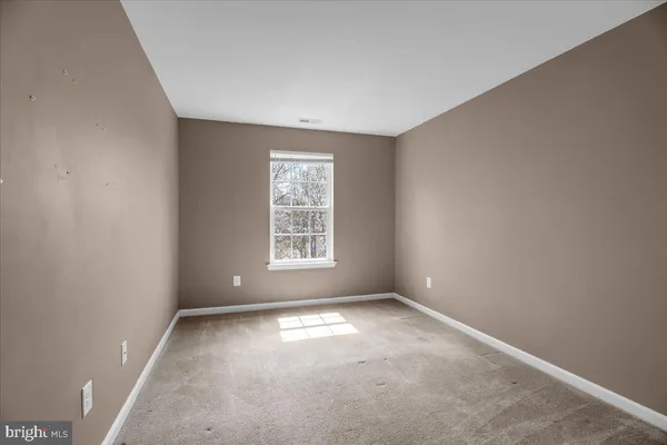 an empty room with a empty space and a window