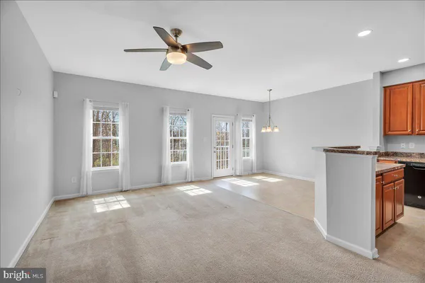 a view of a livingroom with a ceiling fan and window