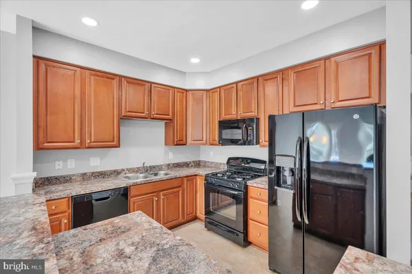 a view of a kitchen with a sink and microwave