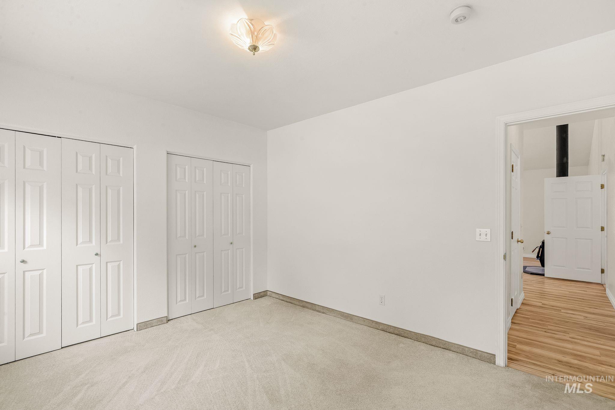 1091 Cedar Ridge Road Kendrick, ID 83537 - Photo 36 of 48 Carpeted room featuring dual bi-fold closet doors, a neutral wall color, and a ceiling-mounted light fixture