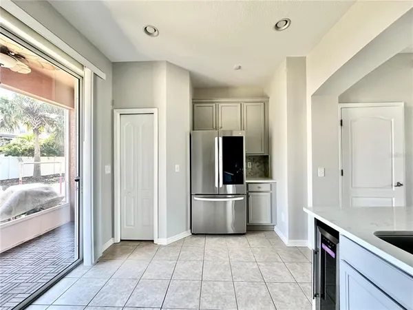 a view of a kitchen with a sink and refrigerator