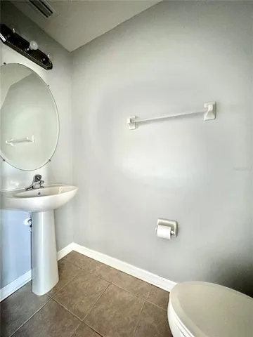 a bathroom with a sink a mirror and toilet
