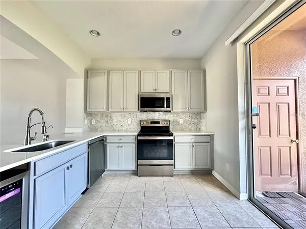 a kitchen with stainless steel appliances granite countertop a stove and a sink