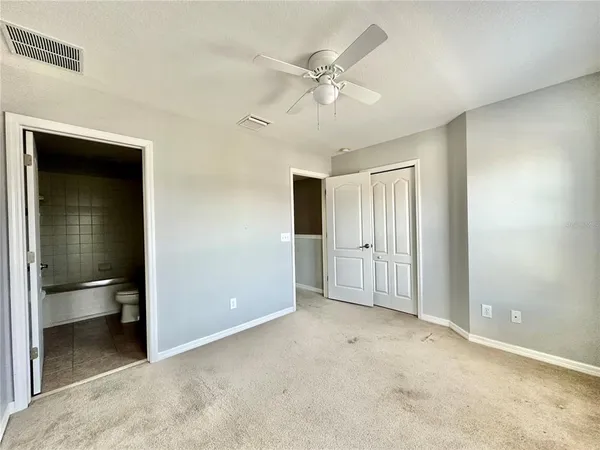 an empty room with a bathroom and a sink