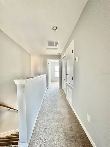 a view of a hallway with staircase