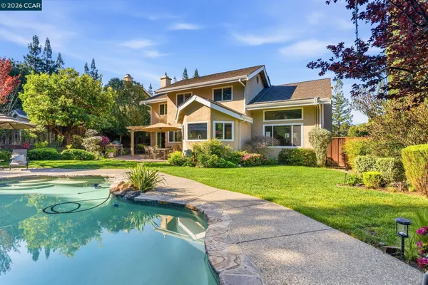 a view of a swimming pool with a yard