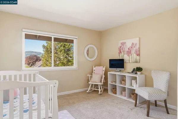 a bedroom with a bed and a potted plant on the dresser