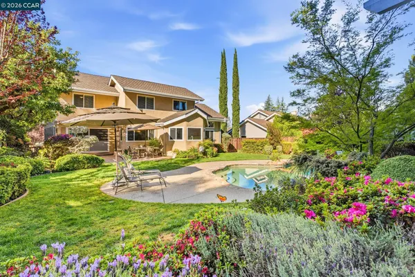 a view of a house with a big yard and potted plants