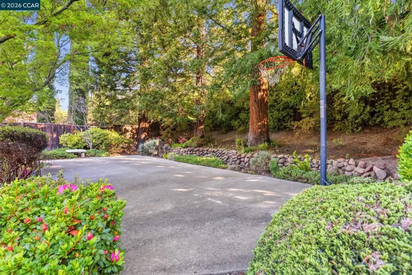 a front view of a house with a yard and a garden