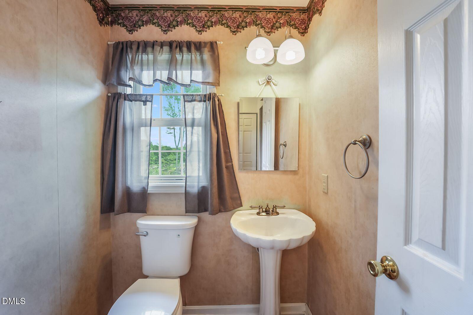 376-t K T K Allen Road Louisburg, NC 27549 - Photo 15 of 49 a bathroom with a toilet sink and mirror