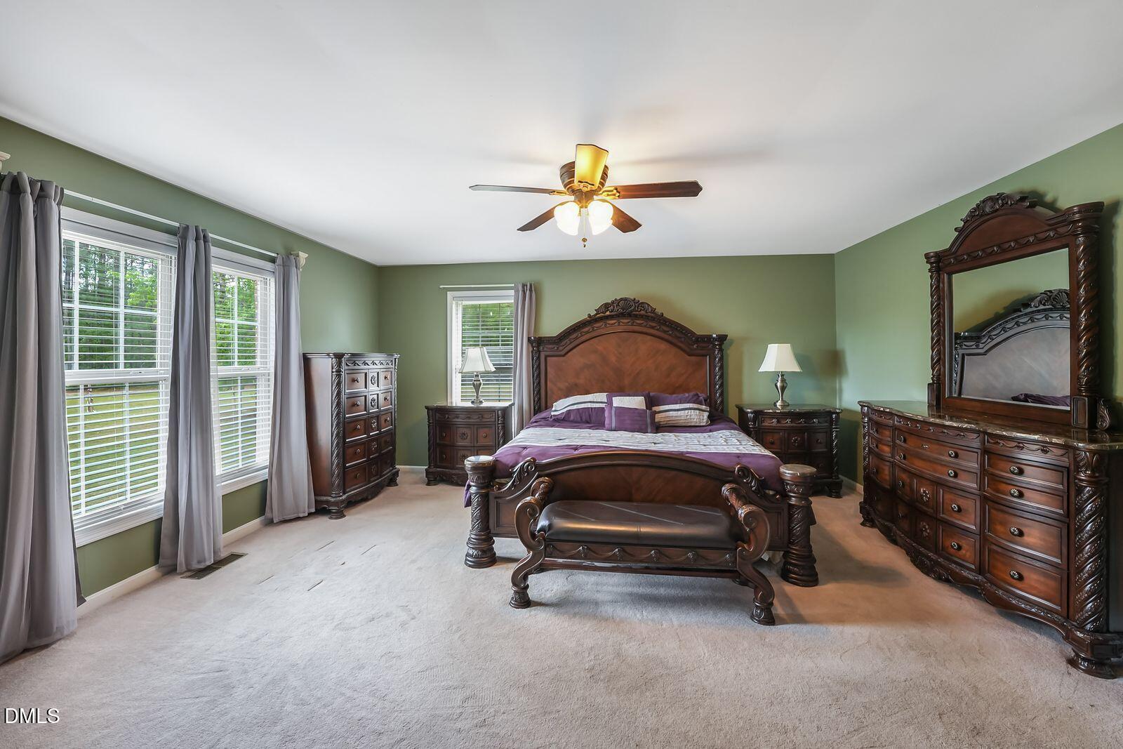 376-t K T K Allen Road Louisburg, NC 27549 - Photo 16 of 49 a bedroom with a bed and a chandelier
